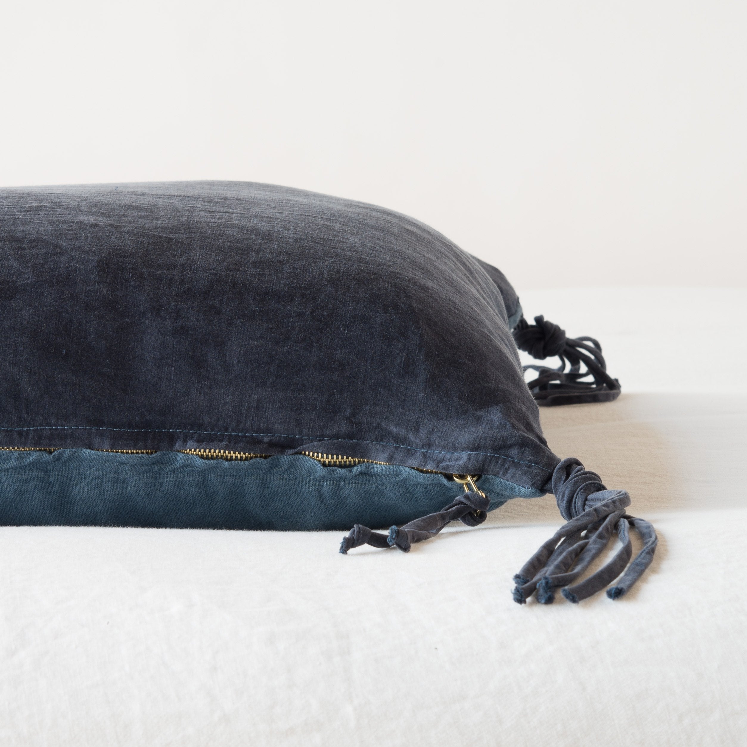 Midnight: Close-up side vew featuring brass zipper with charmeuse pull and linen back.
