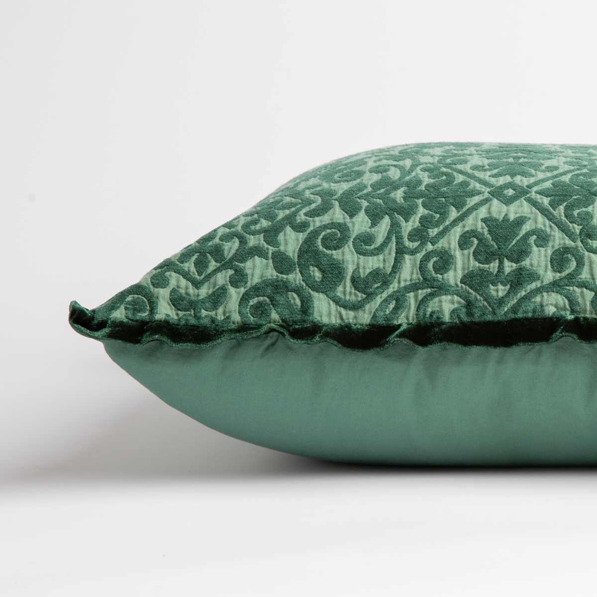 Jade: side view of 18x18 pillow shows cotton sateen back and silk velvet trim detail β close up against a white background.