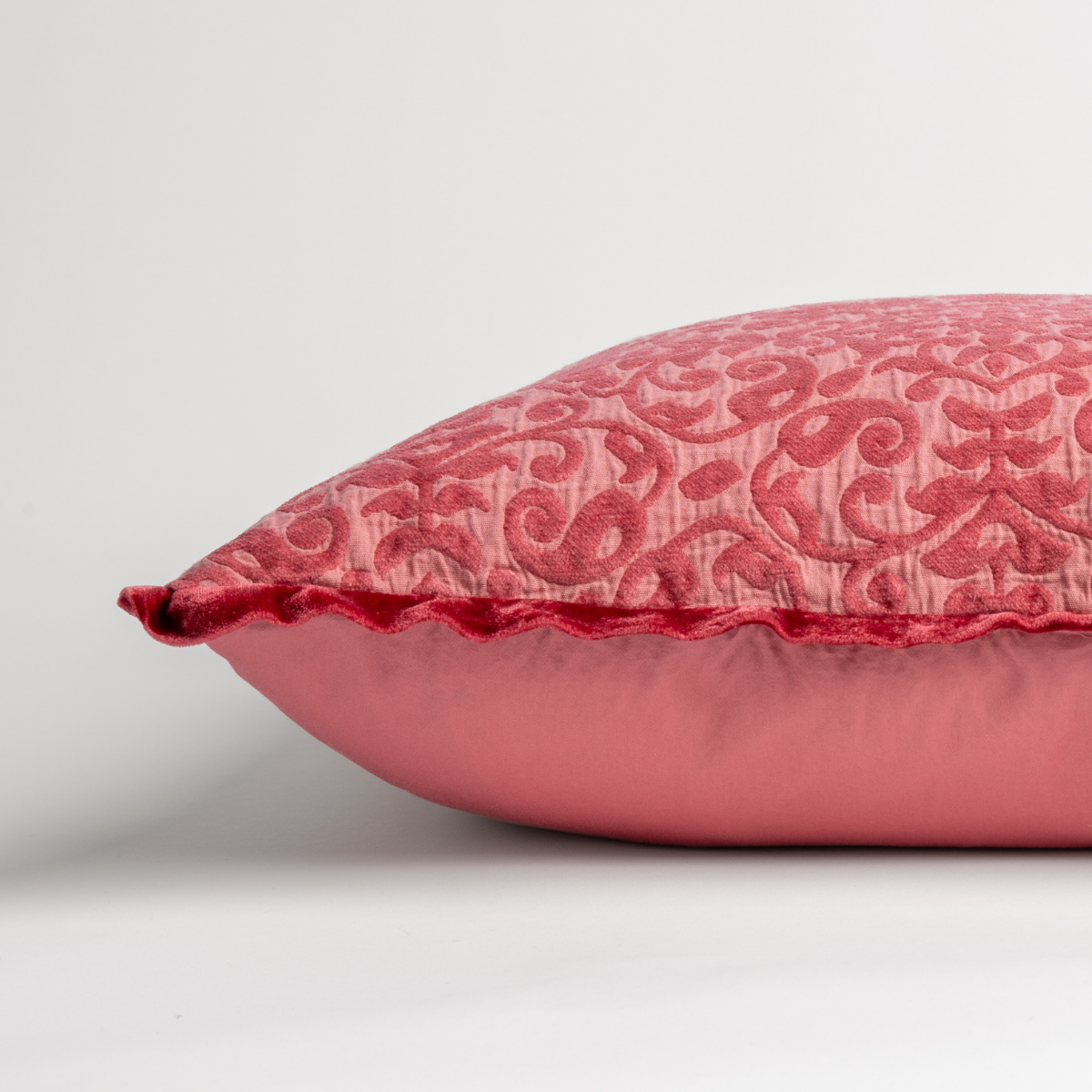 Poppy: side view of 18x18 pillow shows cotton sateen back and silk velvet trim detail β close up against a white background.