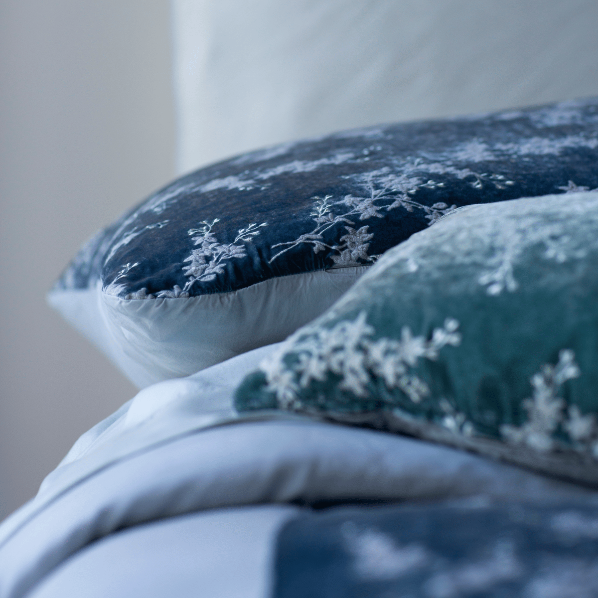 : a close-up of a blue-grey sham in its side with the other products out of focus. 