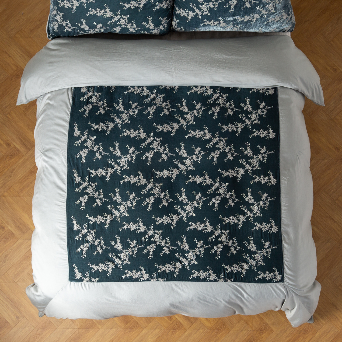 Mineral: An overhead shot of an embroidered silk velvet and tencel duvet cover and matching shams. 