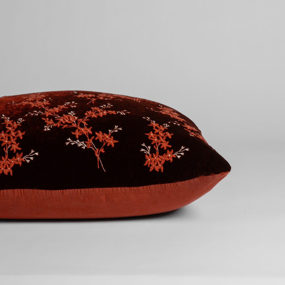 Autumn: A close-up of the sham shown on its side to display the embroidered silk velvet face and tencel back — shown against a white background. 
