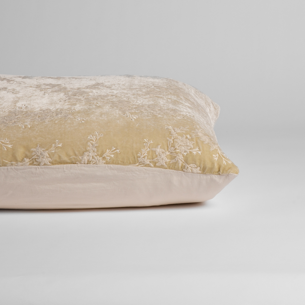 Parchment: A close-up of the sham shown on its side to display the embroidered silk velvet face and tencel back — shown against a white background. 
