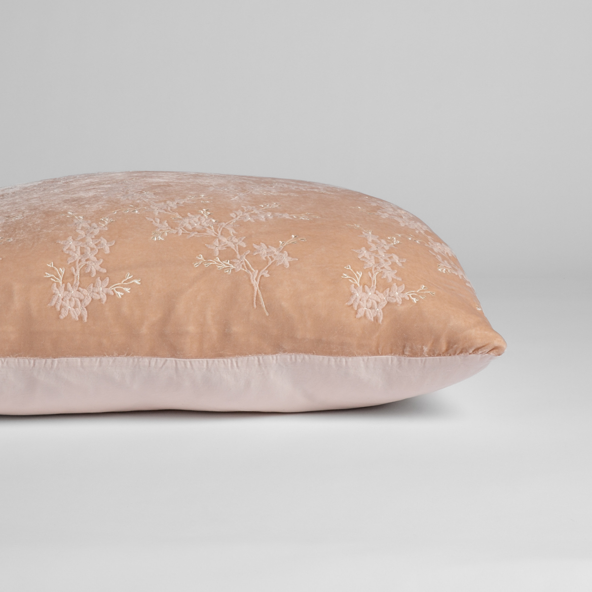 Pearl: A close-up of the sham shown on its side to display the embroidered silk velvet face and tencel back — shown against a white background. 
