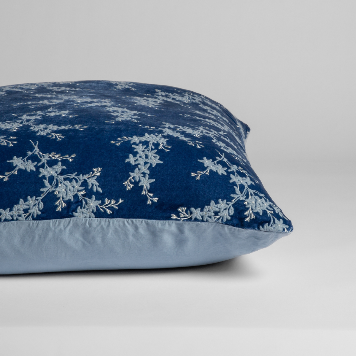 Tahoe Blue:  A close-up of the sham shown on its side to display the embroidered silk velvet face and tencel back — shown against a white background. 

