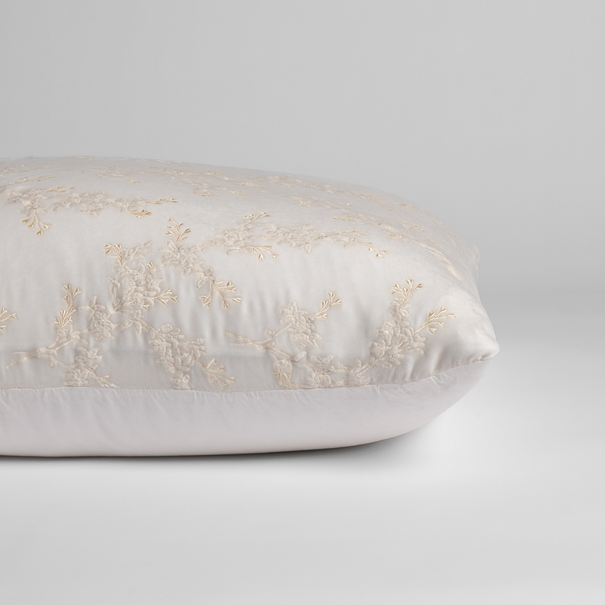 Winter White:  A close-up of the sham shown on its side to display the embroidered silk velvet face and tencel back — shown against a white background. 