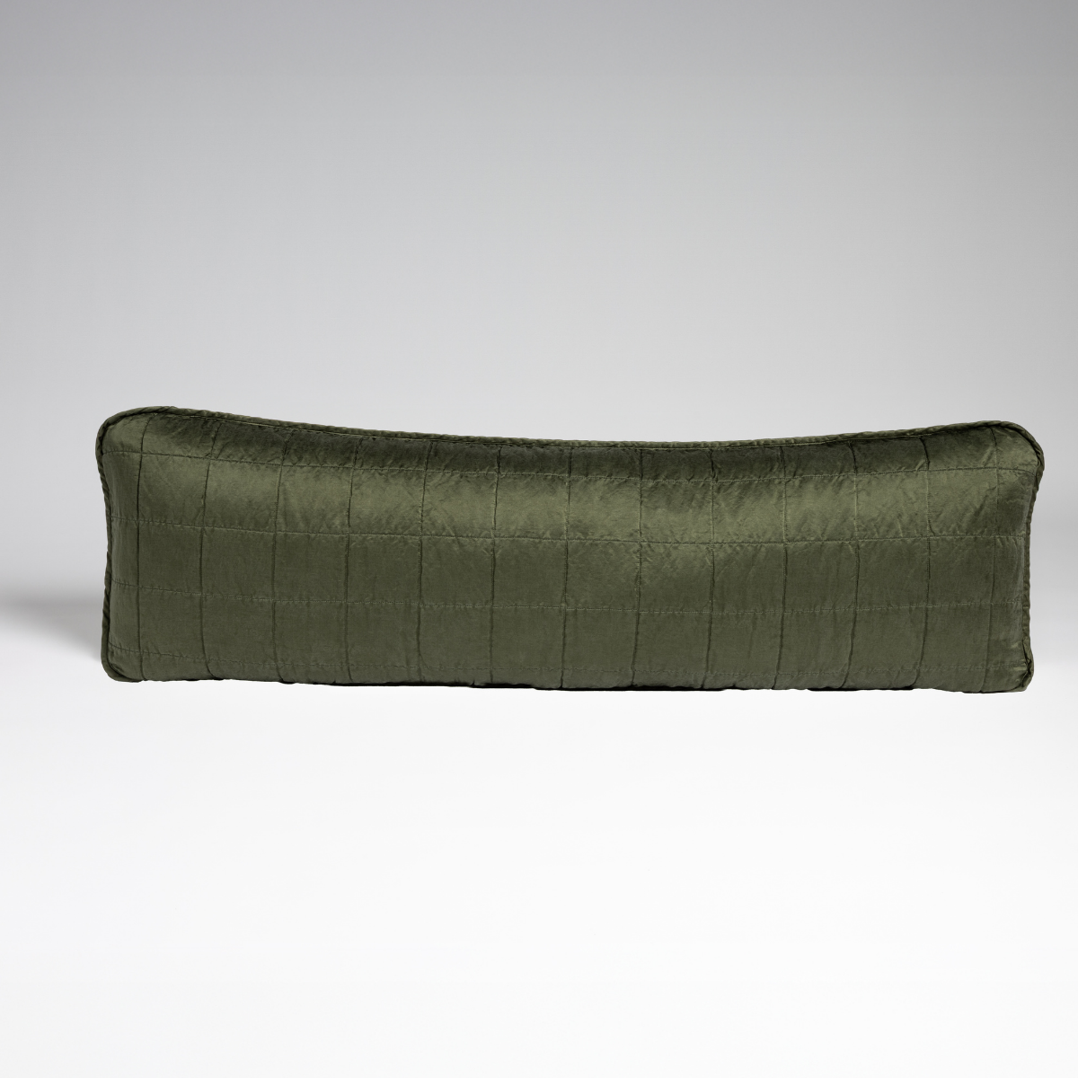 Juniper: A straight-on shot of a square-quilted body pillow in juniper, a deeply saturated dark green, against a white background. 