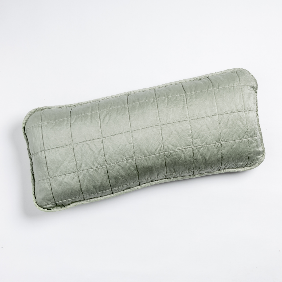 Eucalyptus: An overhead shot of a square-quilted rectangle throw pillow in eucalyptus, a soft light green, against a white background. 