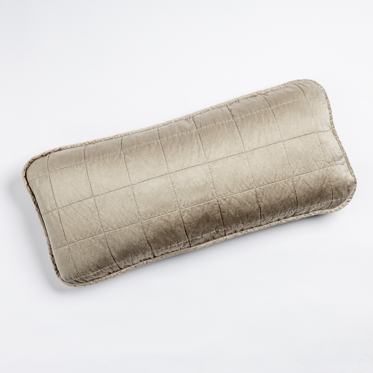 Moonlight: An overhead shot of a square-quilted rectangle throw pillow in moonlight, a saturated, cool, mid-dark grey tone, against a white background. 