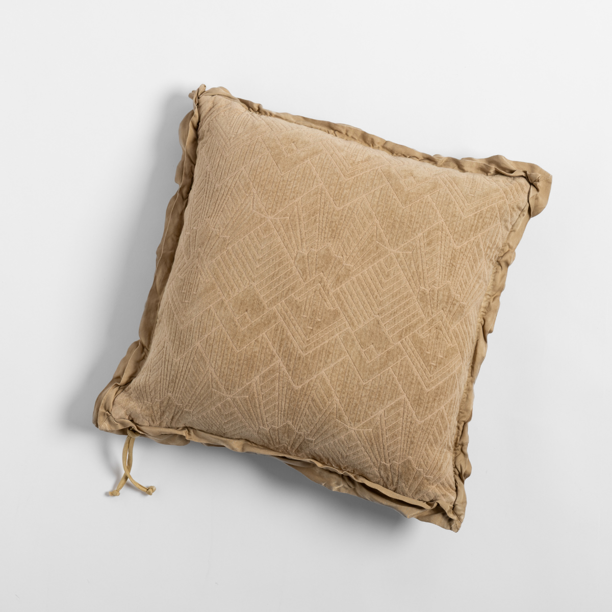 Honeycomb: The chenille side of a textured throw pillow with contrasting ruffled edges, shot from overhead against a plain background.