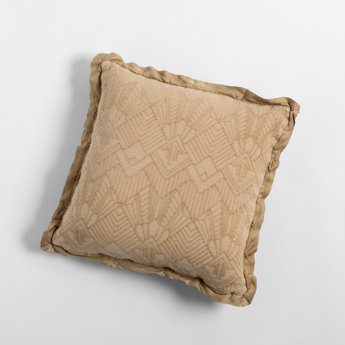 Honeycomb: The cotton jacquard side of a textured throw pillow with contrasting ruffled edges, shot from overhead against a plain background.