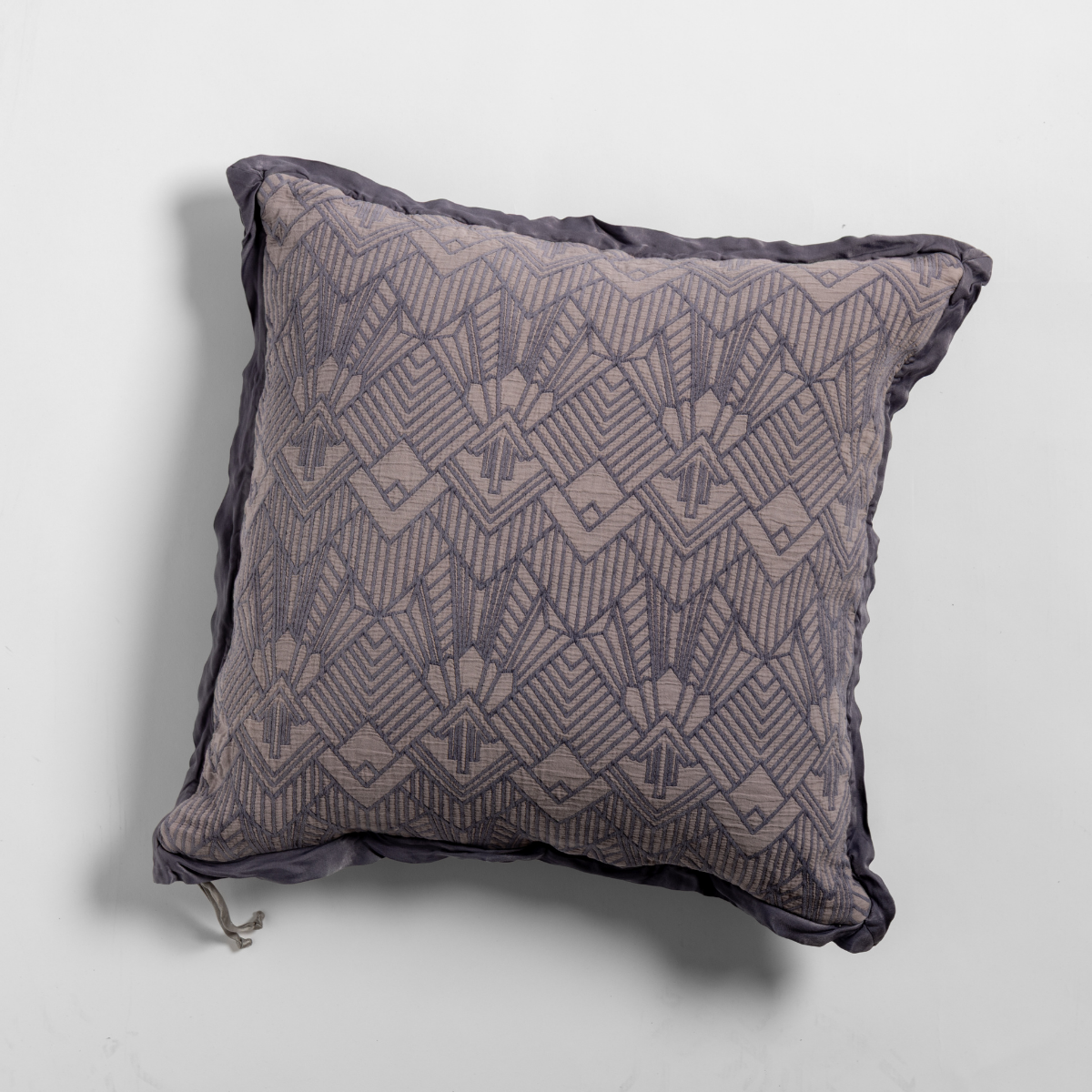 French Lavender: The cotton jacquard side of a textured throw pillow with contrasting ruffled edges, shot from overhead against a plain background.