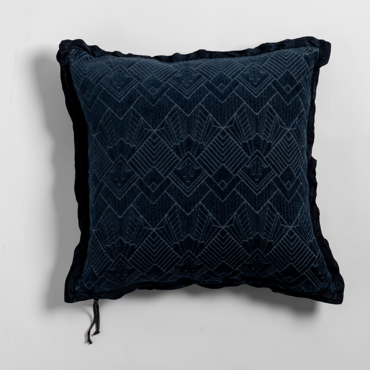 Midnight: The chenille side of a textured throw pillow with contrasting ruffled edges, shot from overhead against a plain background.