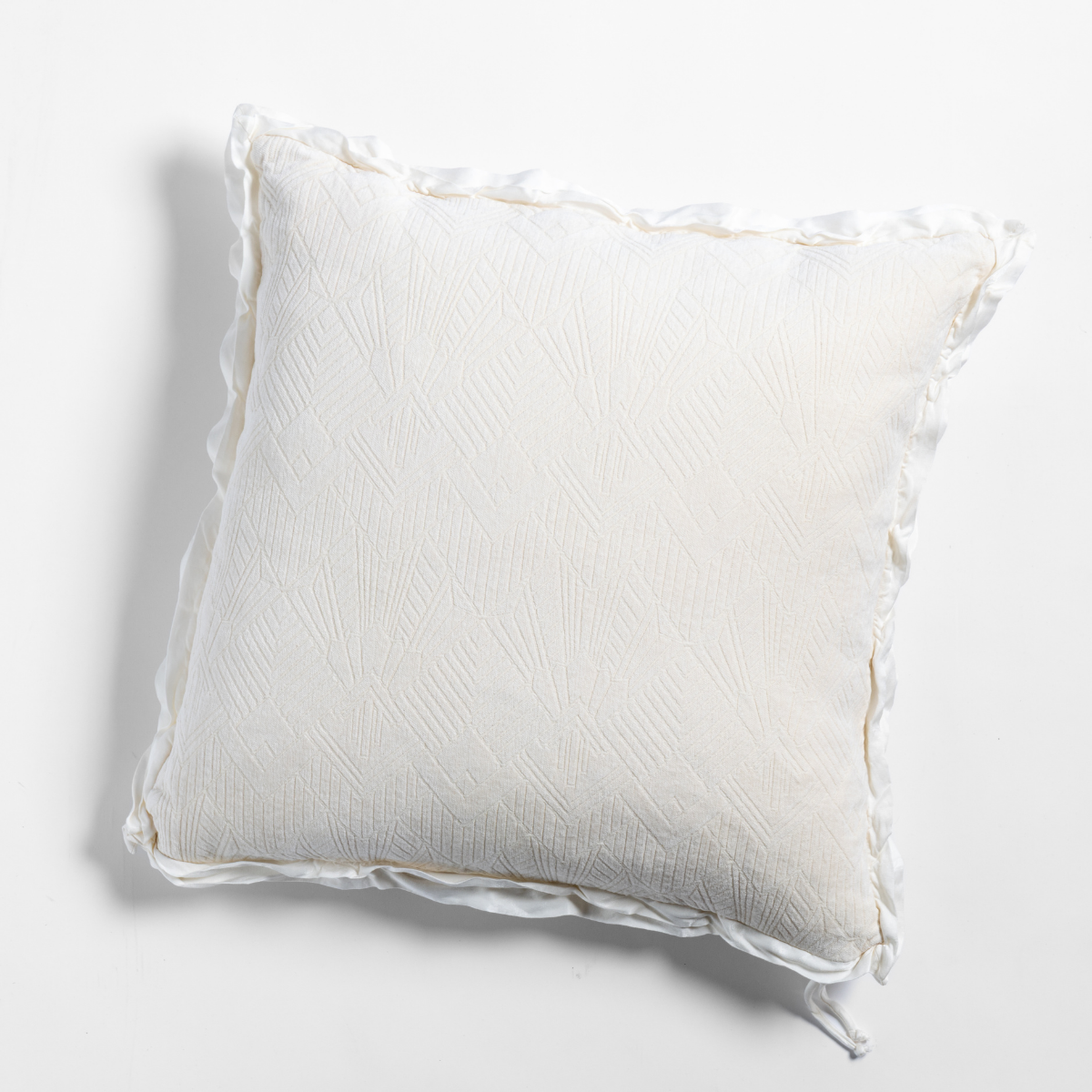 Natural: The chenille side of a textured throw pillow with contrasting ruffled edges, shot from overhead against a plain background.
