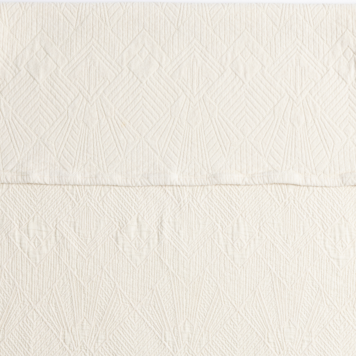 Natural: a close-up showing the chenille jacquard on the top half and cotton jacquard on the bottom in natural, a warm neutral