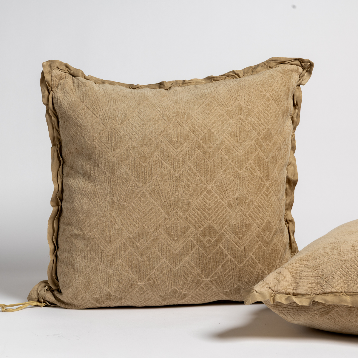 Honeycomb: Two art deco patterned shams, one upright and one on its side, against a plain background.