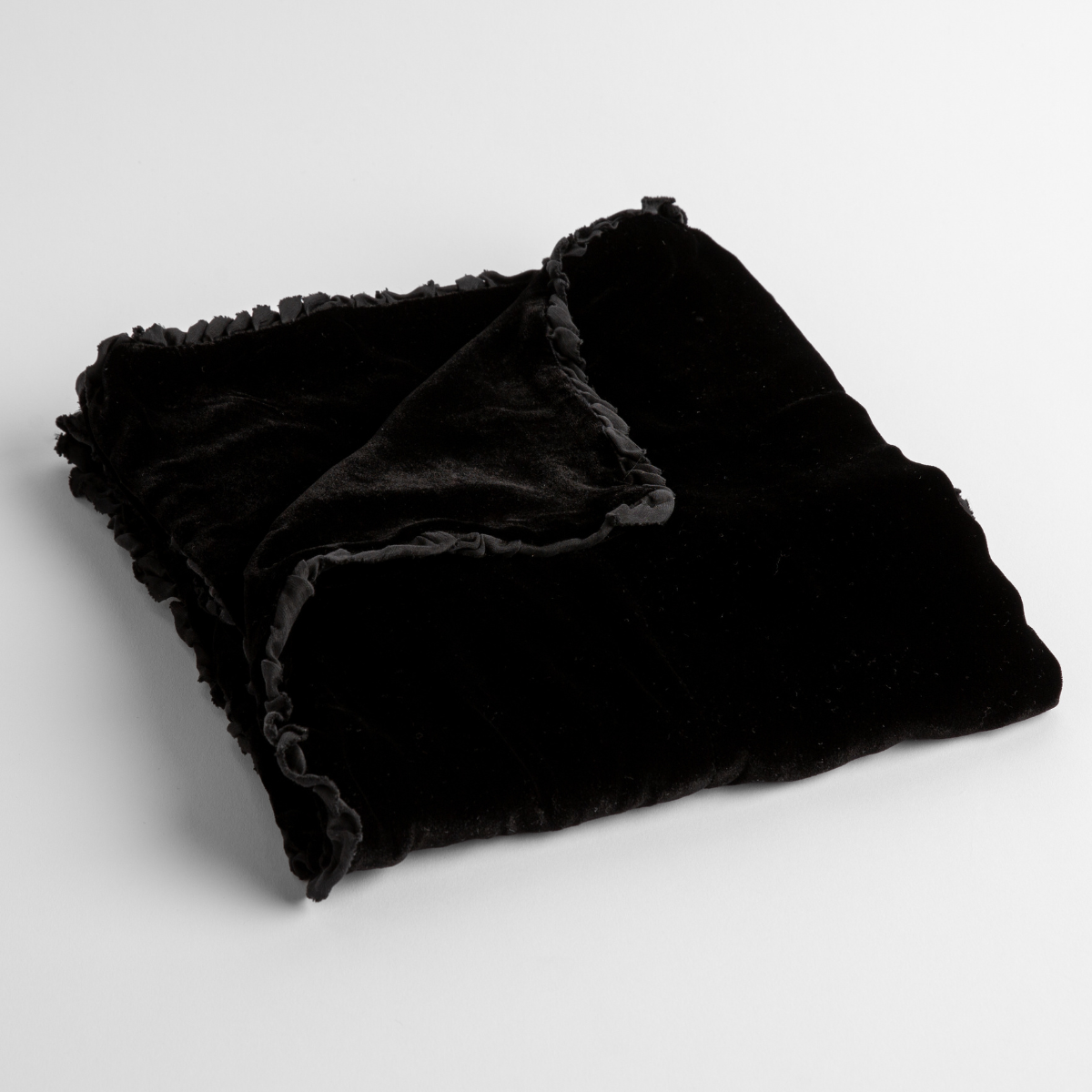 Corvino:  silk velvet baby blanket with charmeuse trim shown slightly overhead with a corner folded back to show trim detail against a white background. 