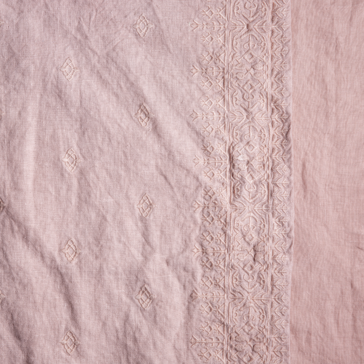 Rouge: A close up of embroidered midweight linen fabric in rouge, a mid-tone blush pink.