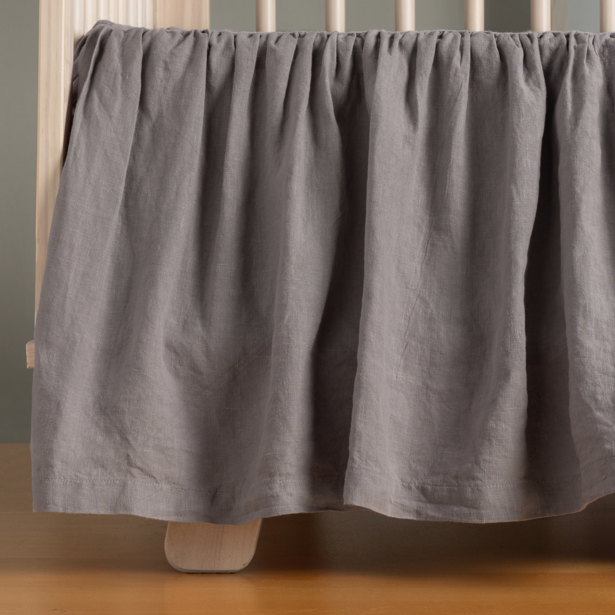 French Lavender: linen crib skirt shown on a crib without a mattress. 