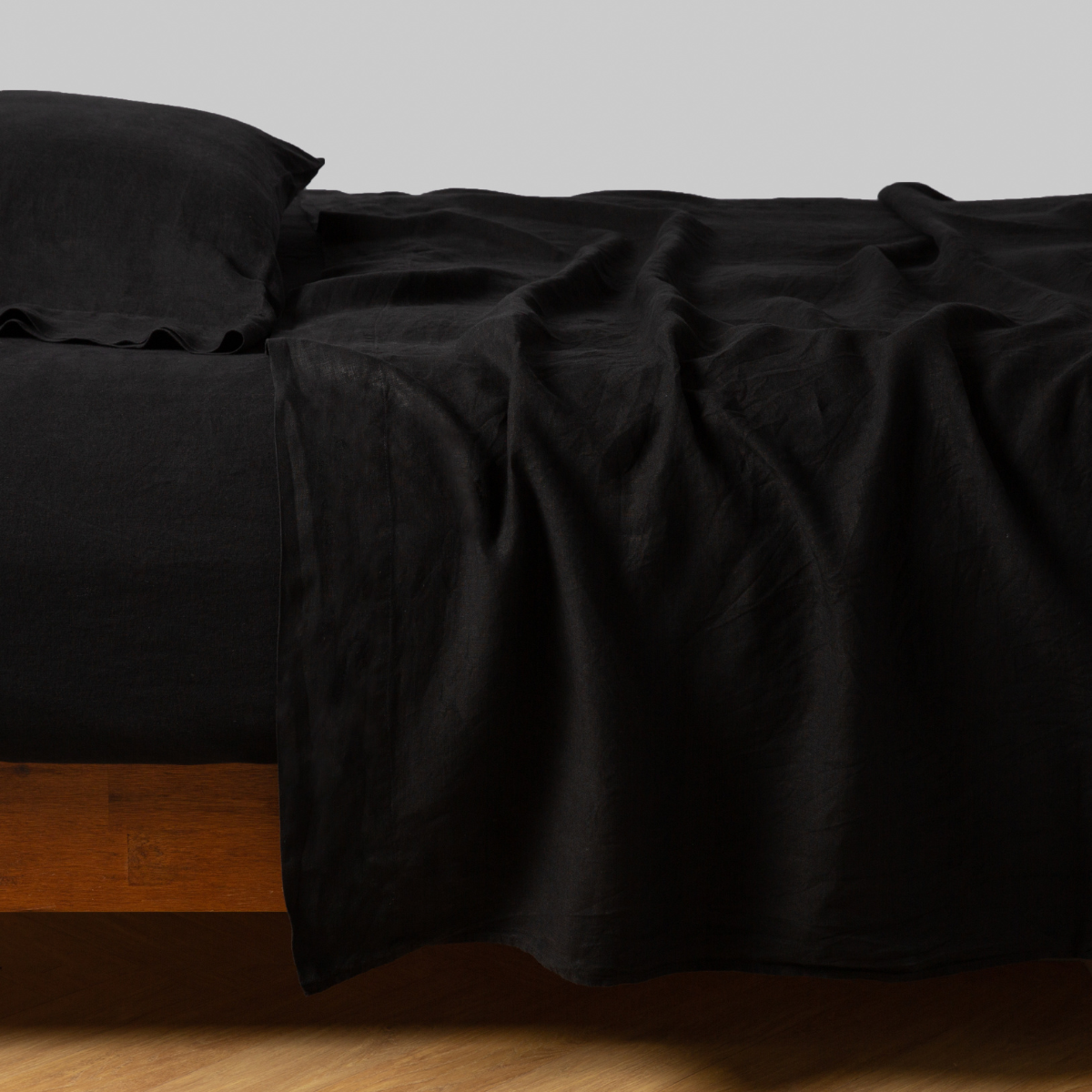 Corvino: sleeping pillow with matching rumpled sheeting - side view.