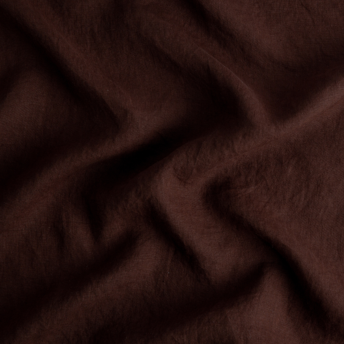 Mahogany: A close up of linen in mahogany, a deep, earthen, reddish brown. 