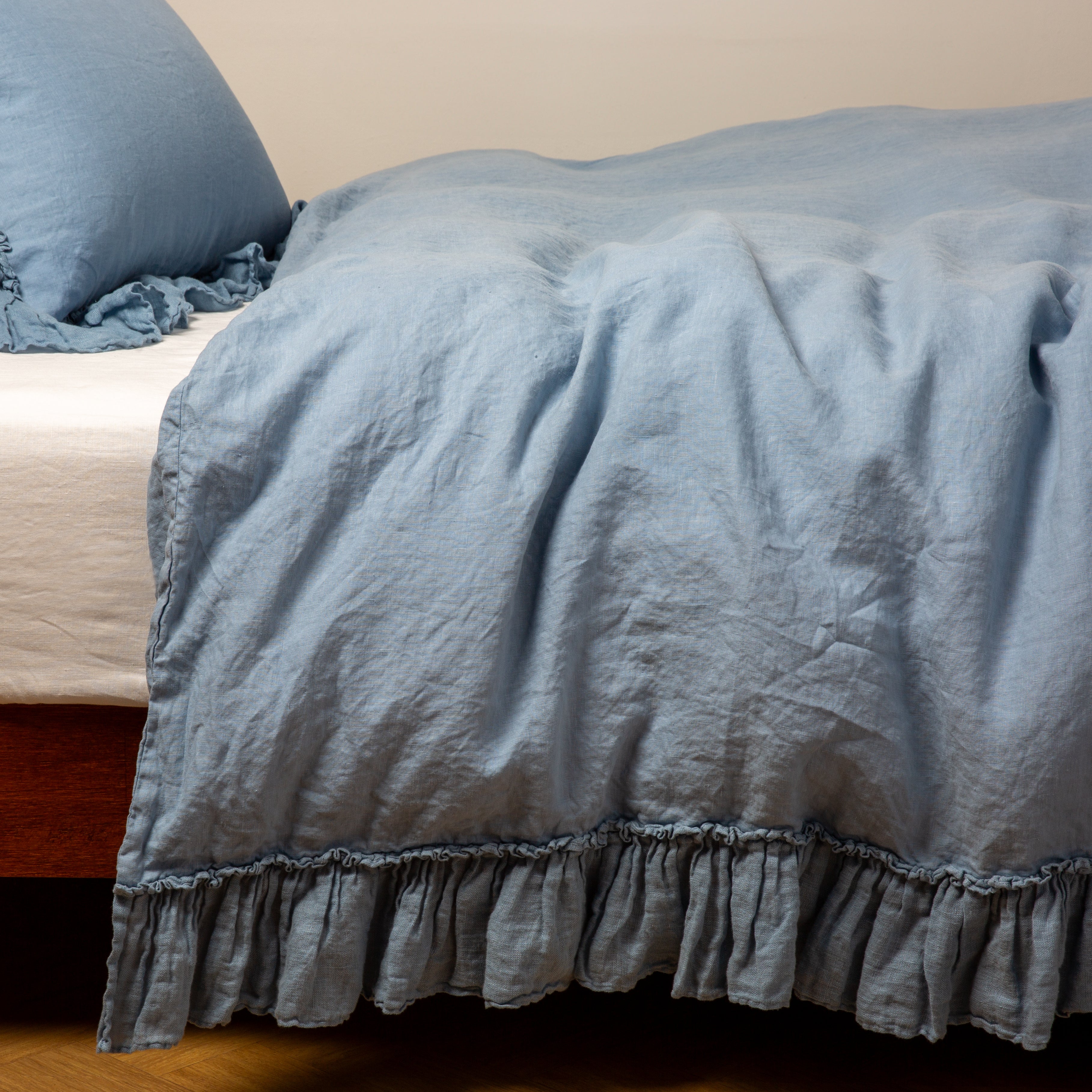 Tahoe Blue: duvet cover folded back over a white fitted sheet, shown with matching sham against a plain background - side view.