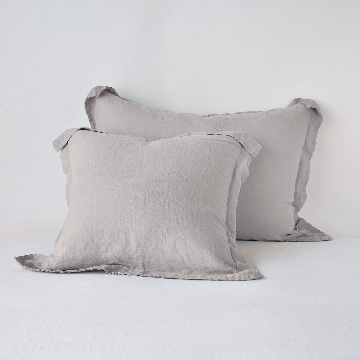 Fog: Two shams leaning upright against a white background.
