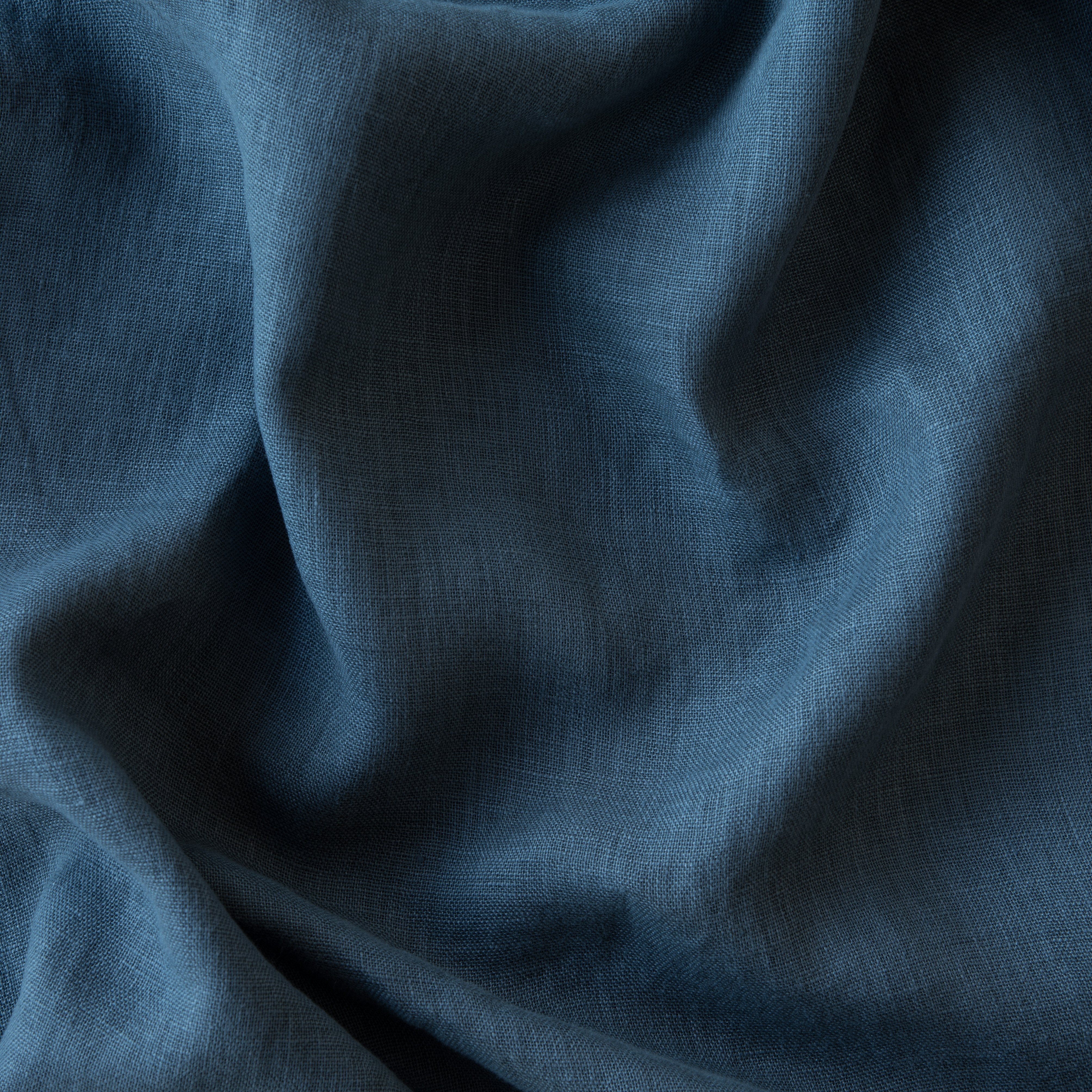 Midnight: A close up of linen whisper, our lightweight linen gauze, in midnight, a rich indigo tone. 