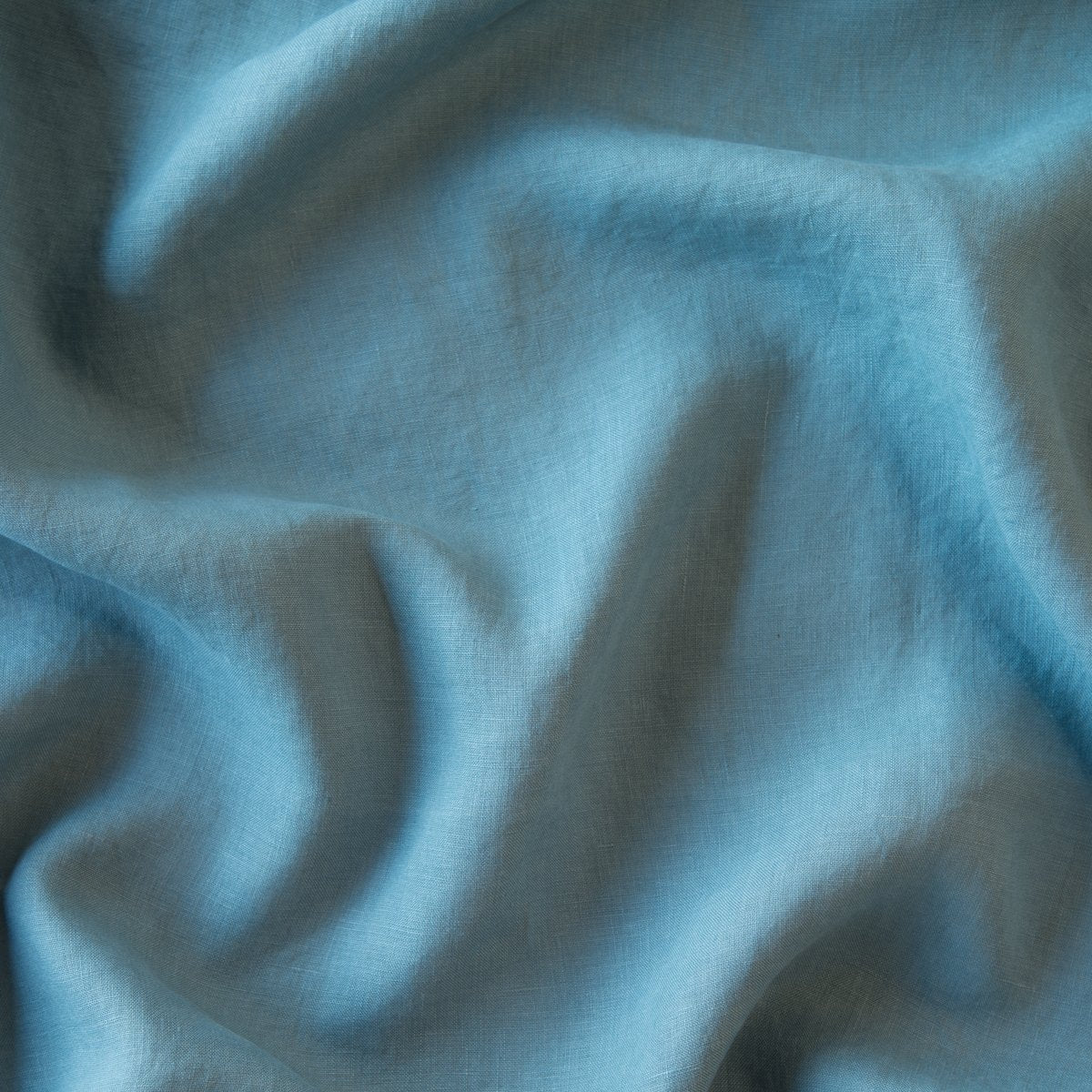 Cenote: : A close up of linen in cenote, a vibrant, ocean-inspired blue-green.