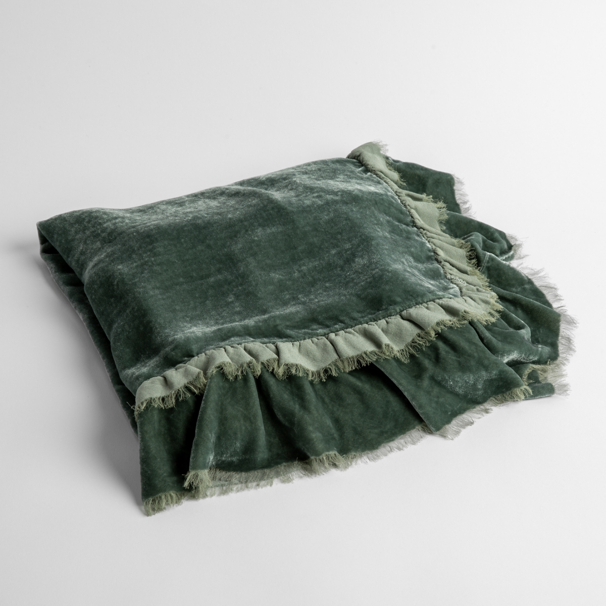 Eucalyptus:  an overhead shot of a folded silk velvet baby blanket with a raw-edged eyelash ruffle detail.