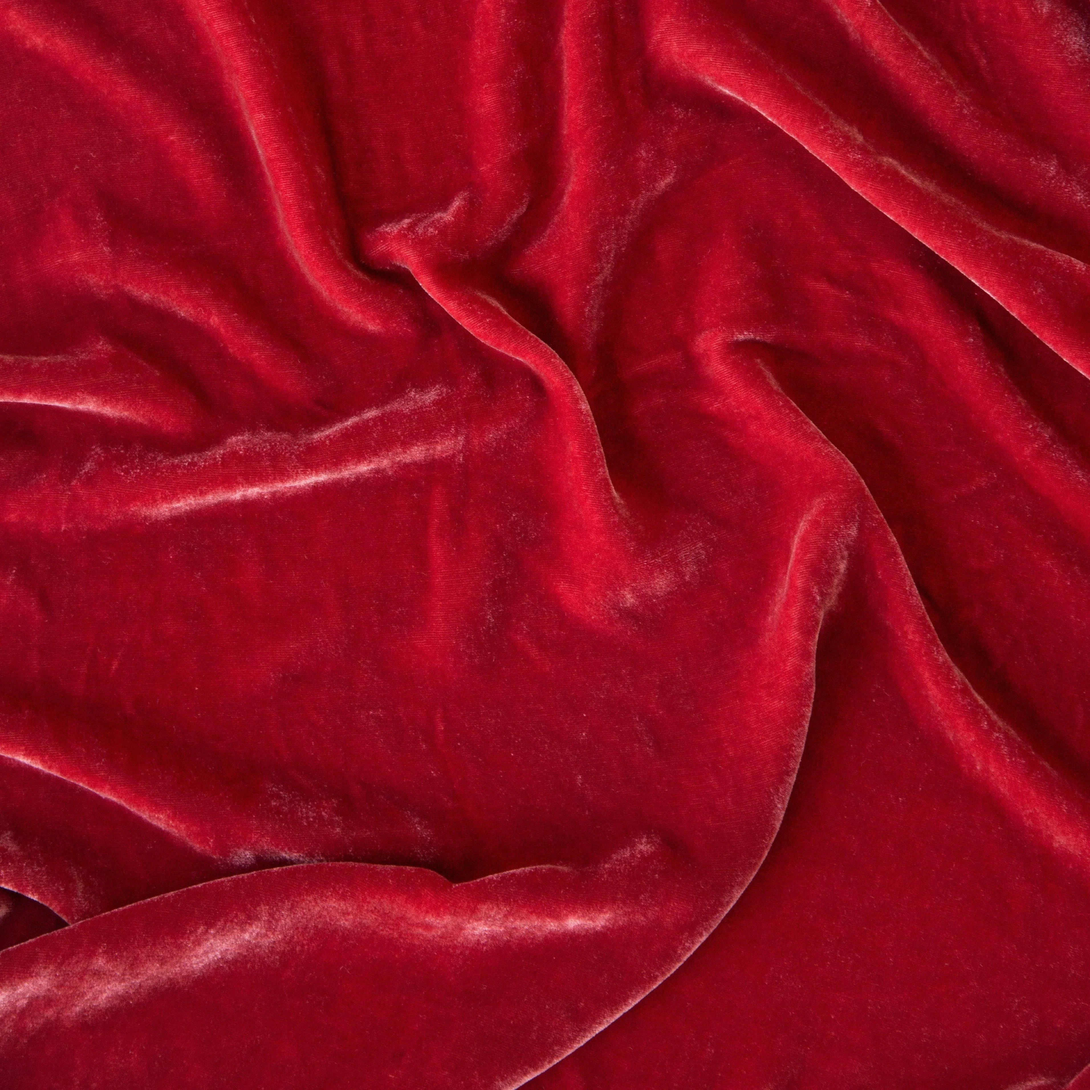 Poppy: A close up of silk velvet in poppy, a vibrant coral pink. 