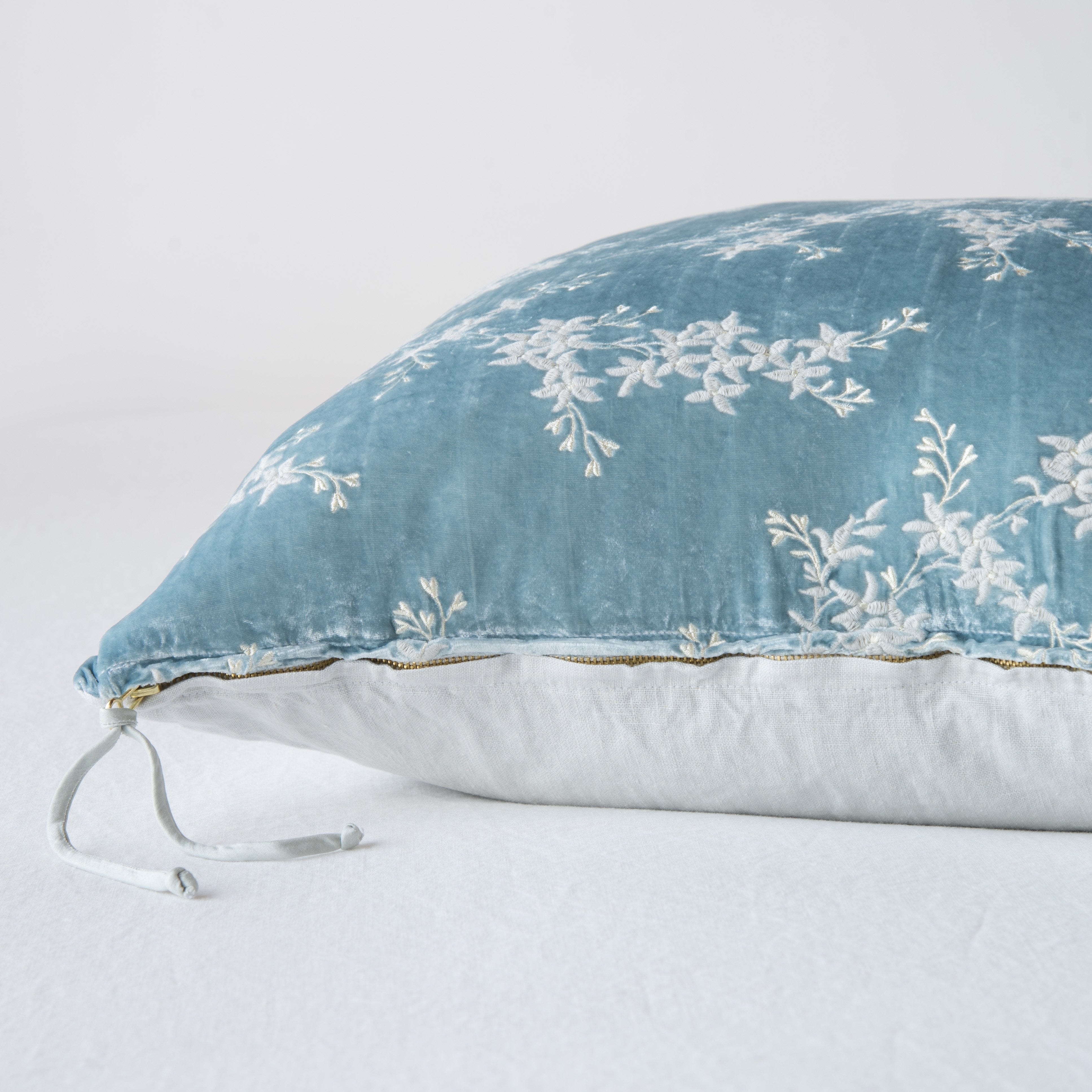 Cloud: Close-up side vew featuring brass zipper with charmeuse pull, and linen back.