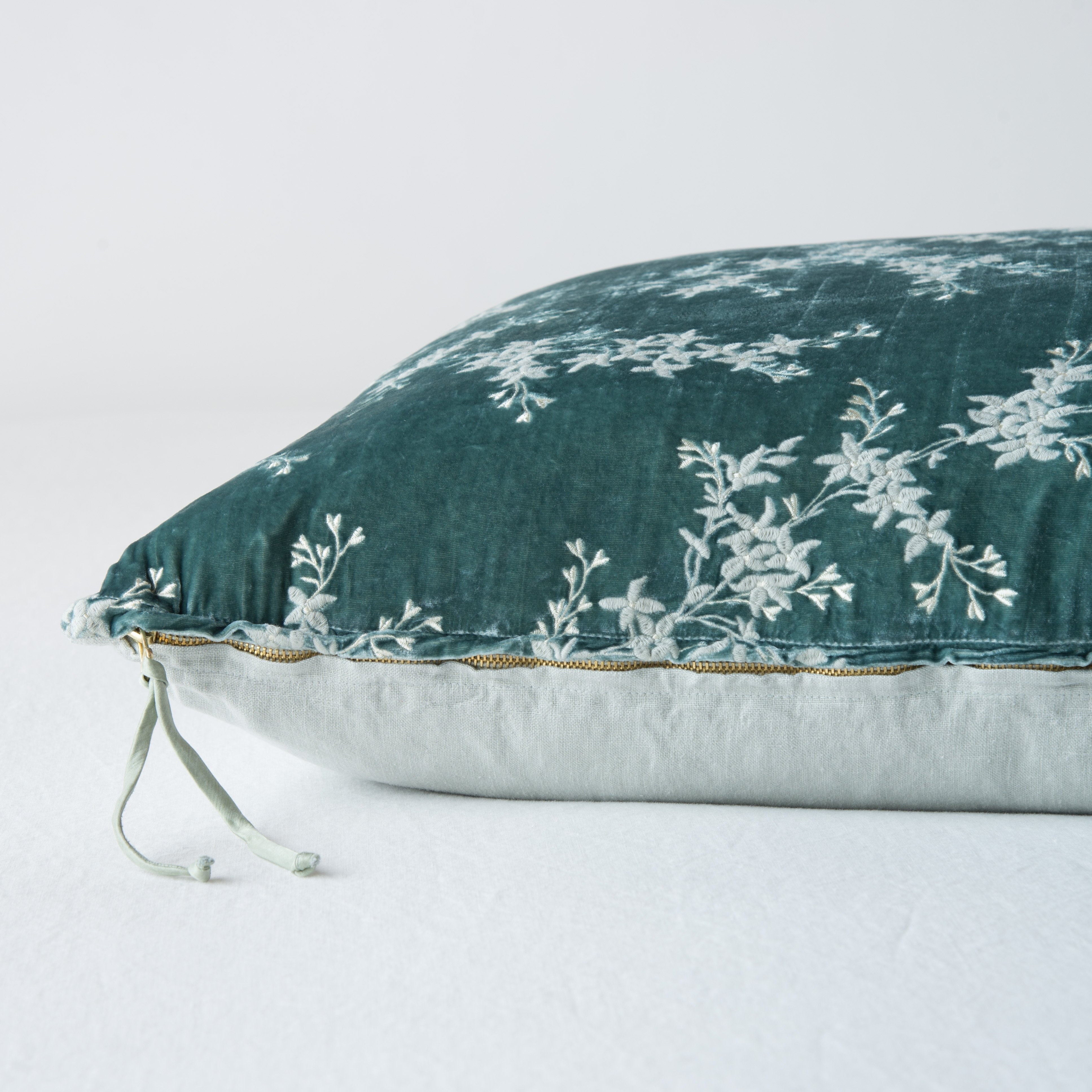 Eucalyptus: Close-up side vew featuring brass zipper with charmeuse pull, and linen back.