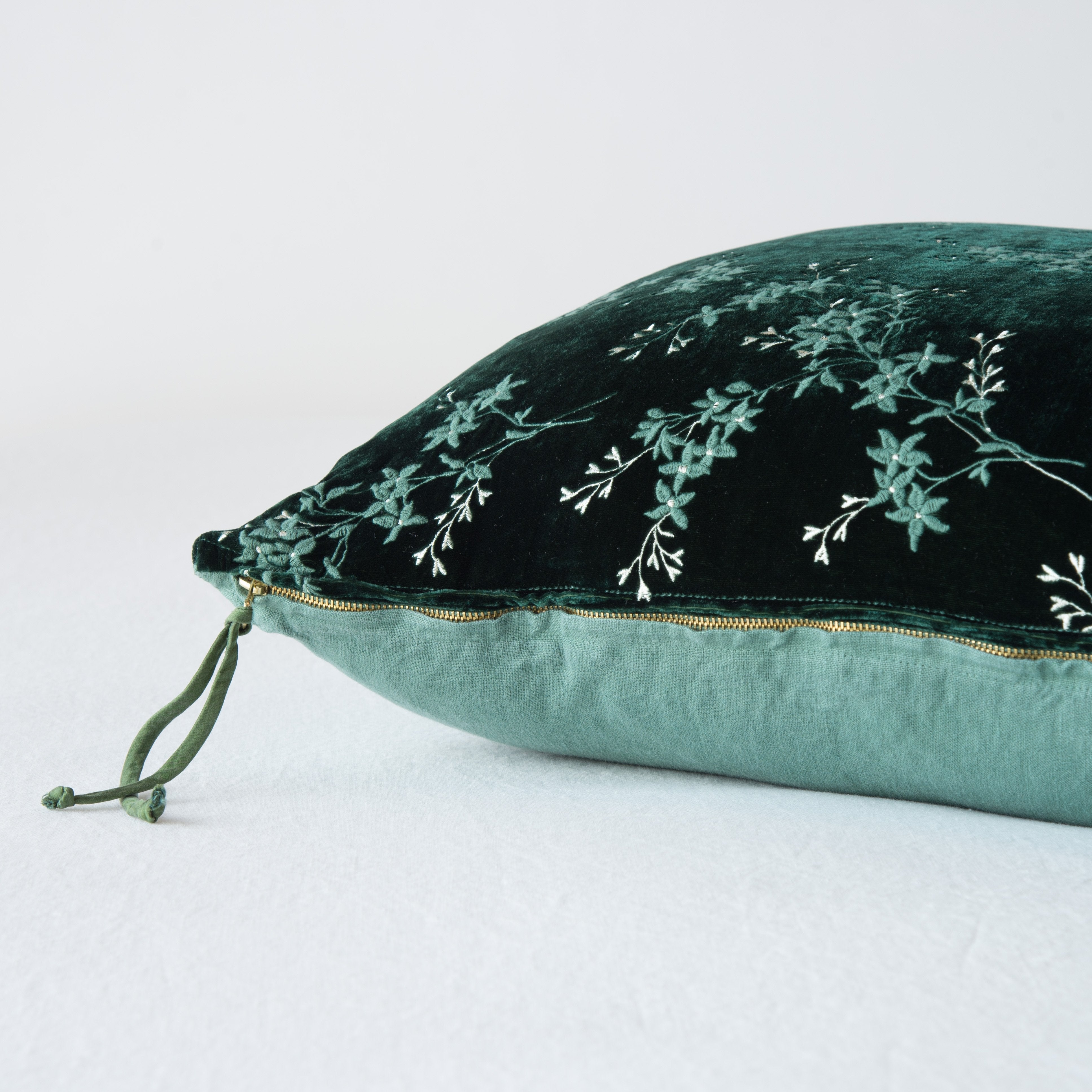 Jade: Close-up side vew featuring brass zipper with charmeuse pull, and linen back.