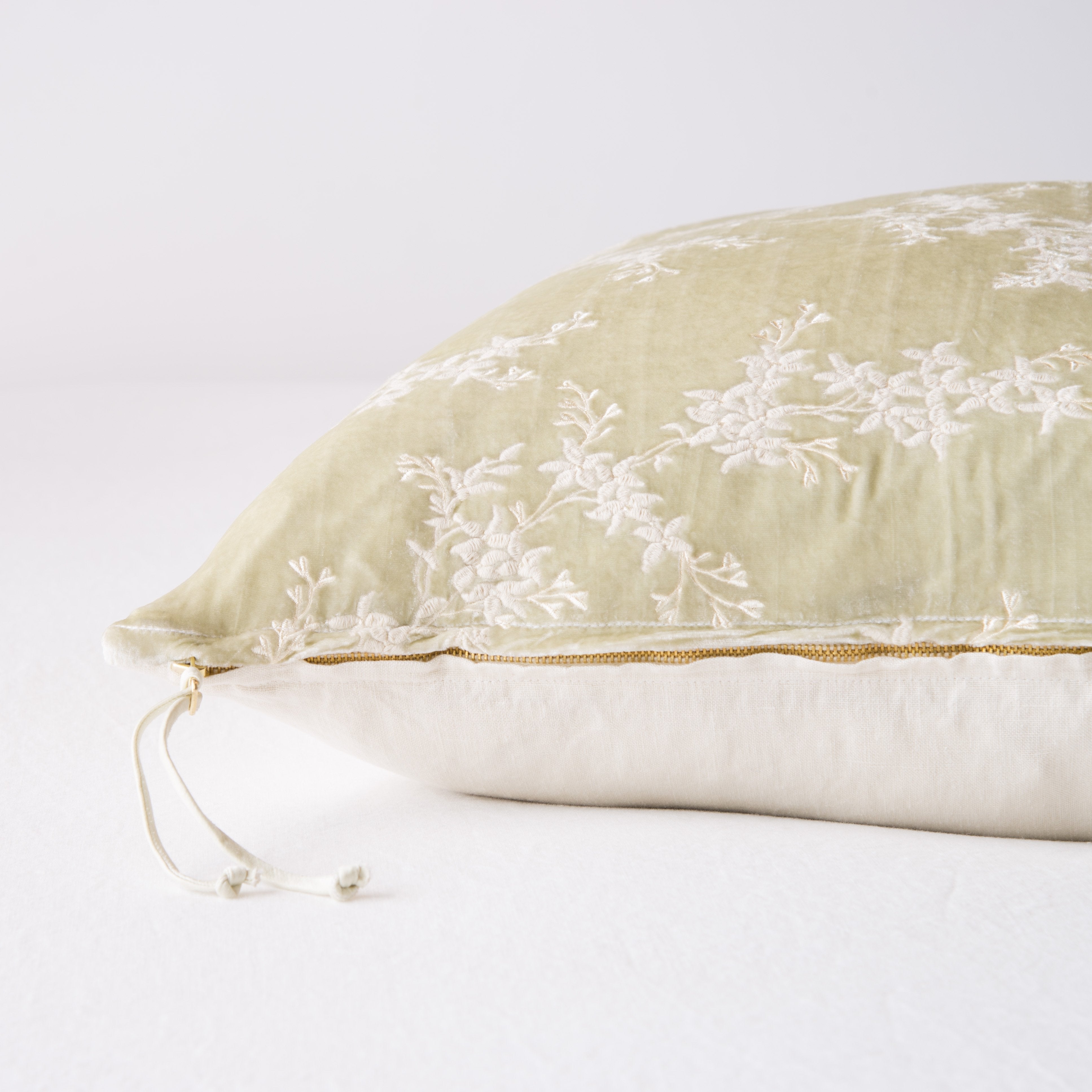 Parchment: Close-up side vew featuring brass zipper with charmeuse pull, and linen back.