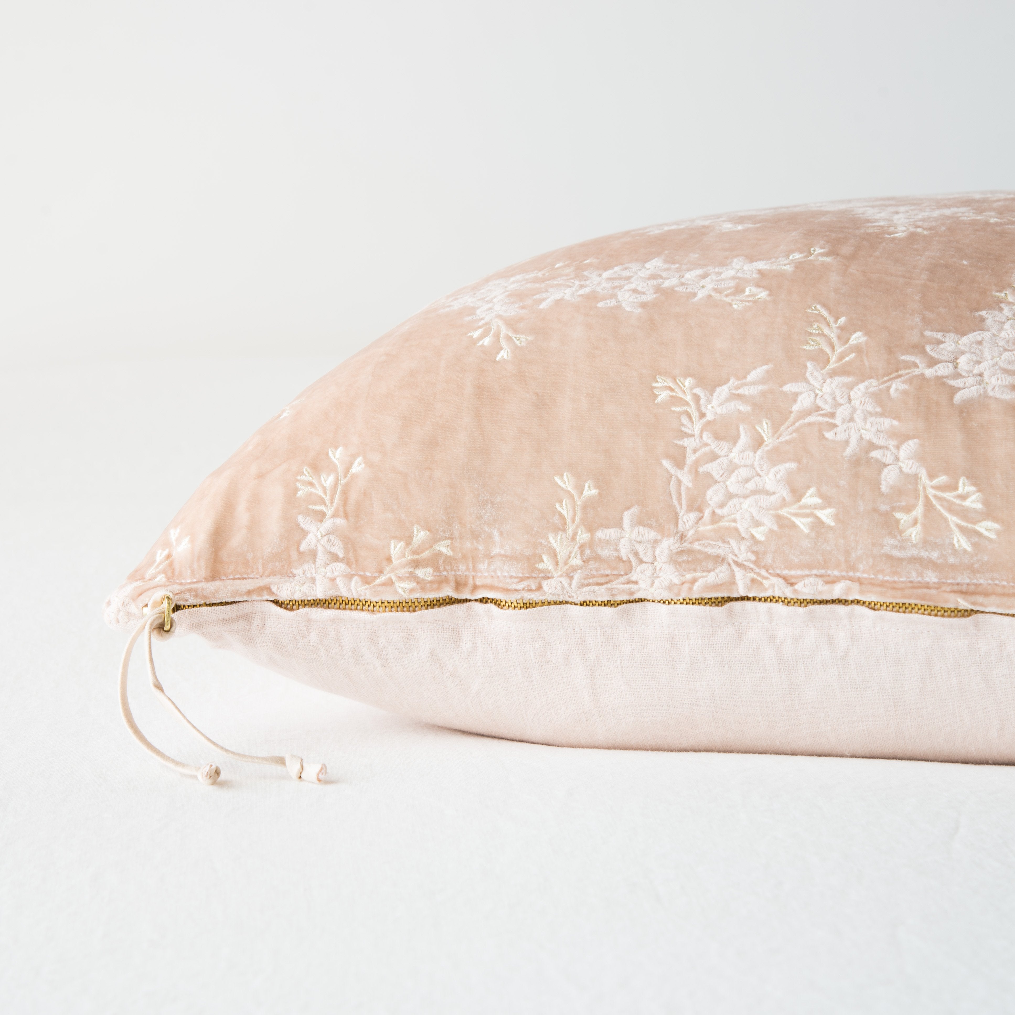 Pearl: Close-up side vew featuring brass zipper with charmeuse pull, and linen back.