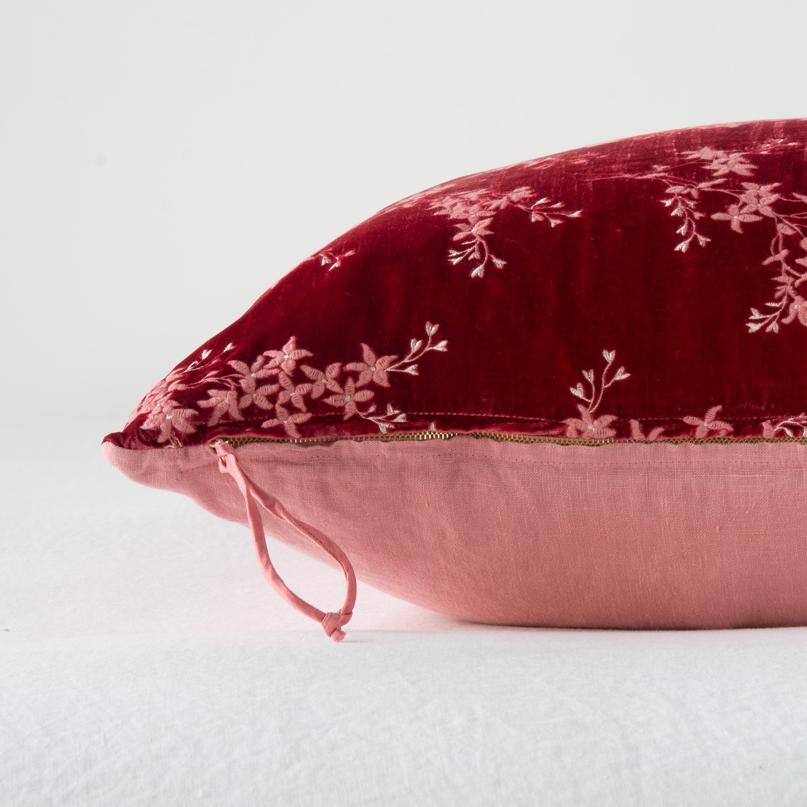 Poppy: Close-up side vew featuring brass zipper with charmeuse pull, and linen back.
