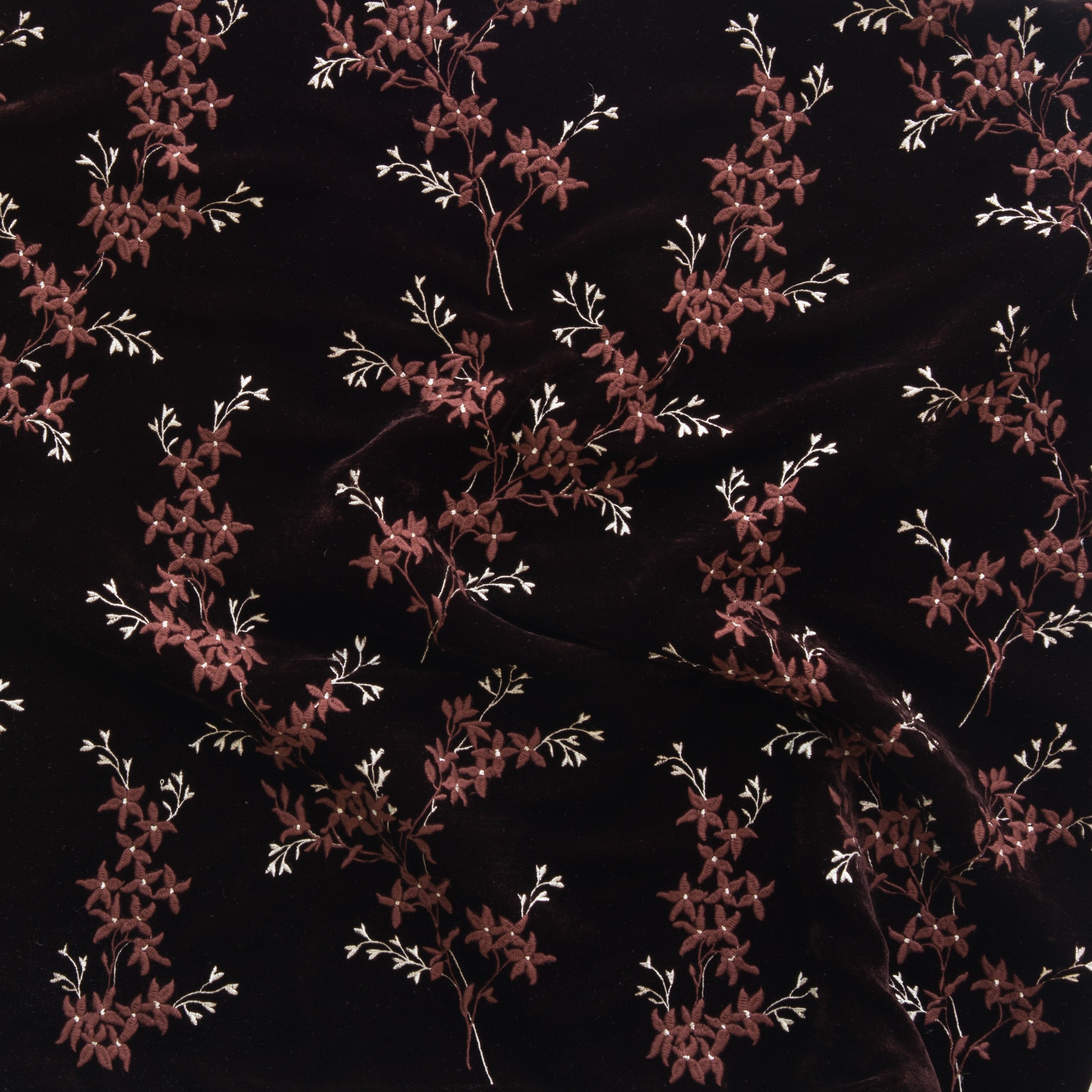 Mahogany: A close up of Lynette embroidered silk velvet, in mahogany, a deep, earthen, reddish brown. 