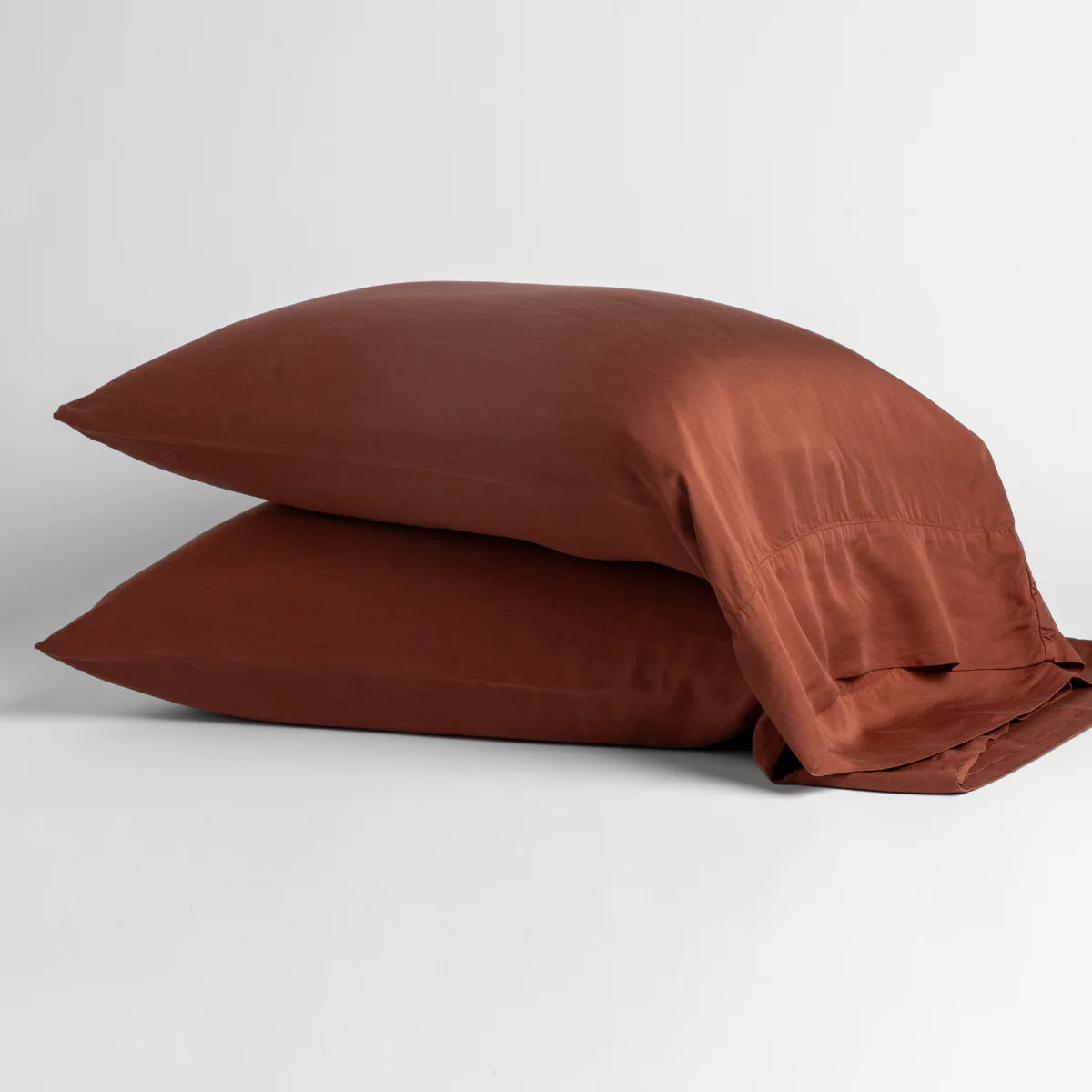 Autumn: sleeping pillows stacked neatly against a white backdrop - side view.
