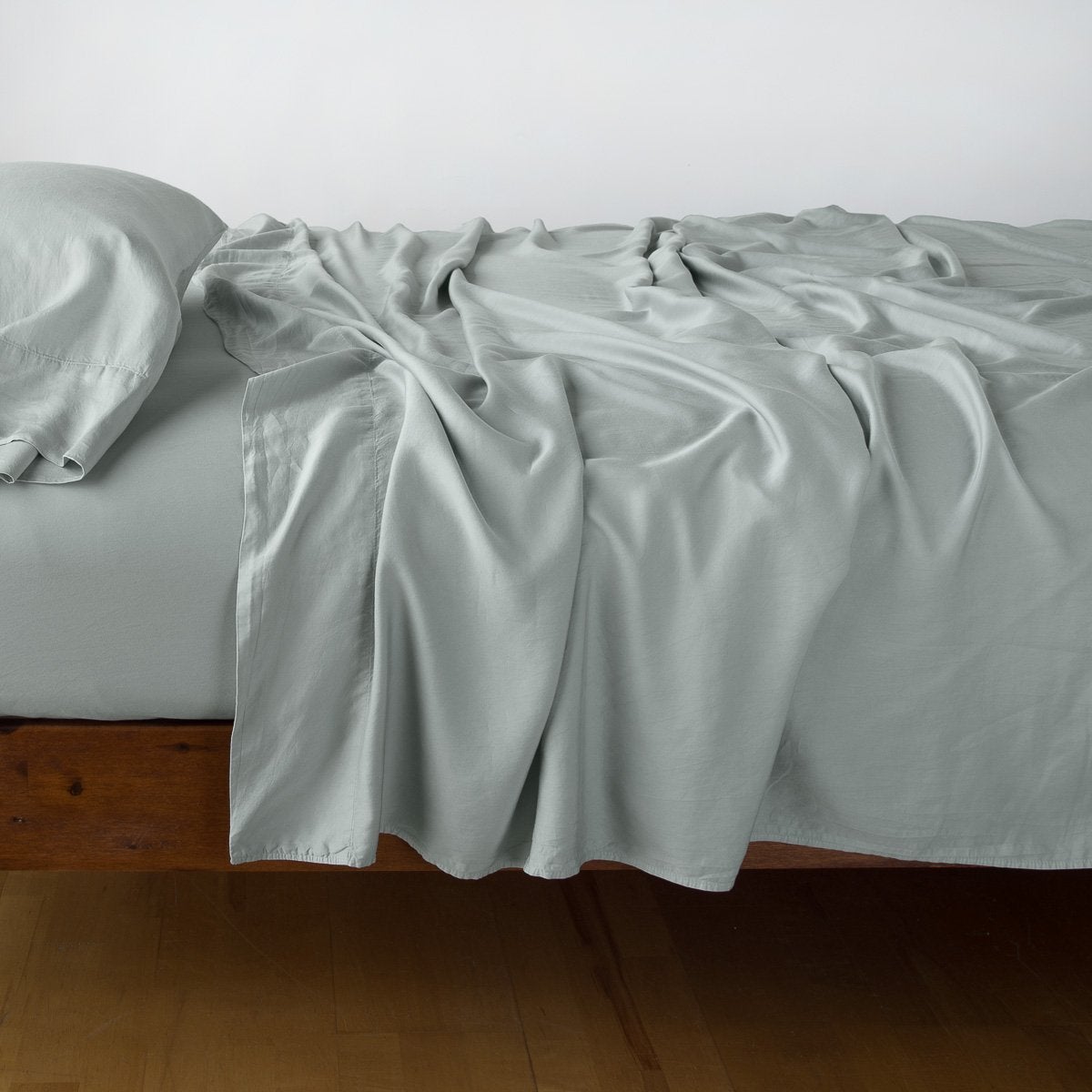 Eucalyptus: sleeping pillow with matching rumpled sheeting - side view.