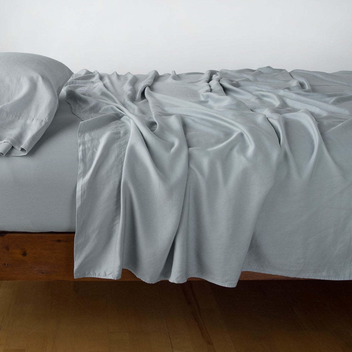 Mineral: sleeping pillow with matching rumpled sheeting - side view.