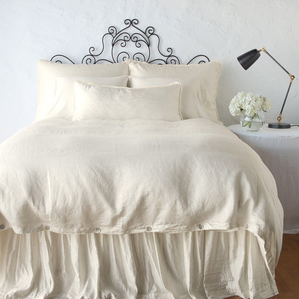 Parchment: duvet cover with matching pillows and bed skirt - end of bed view.