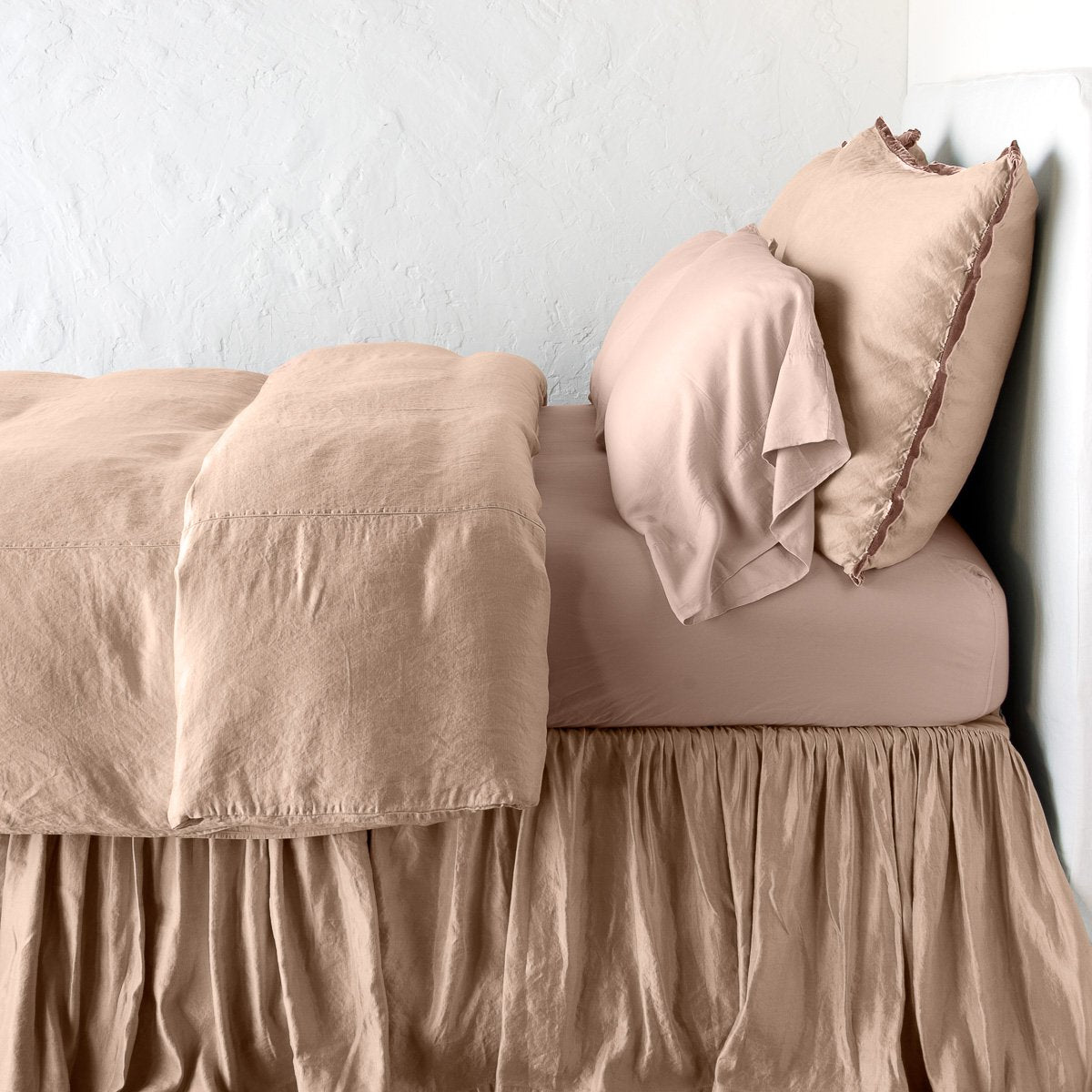 Rouge: duvet cover with matching pillows and bed skirt - side view.