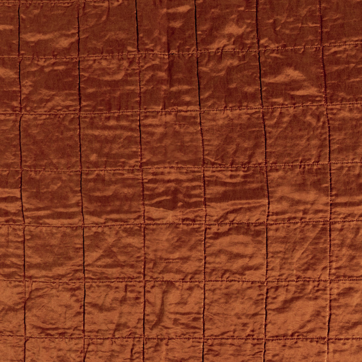 Autumn: A shot of square-quilted charmeuse in Autumn, a rich terracotta tone. 