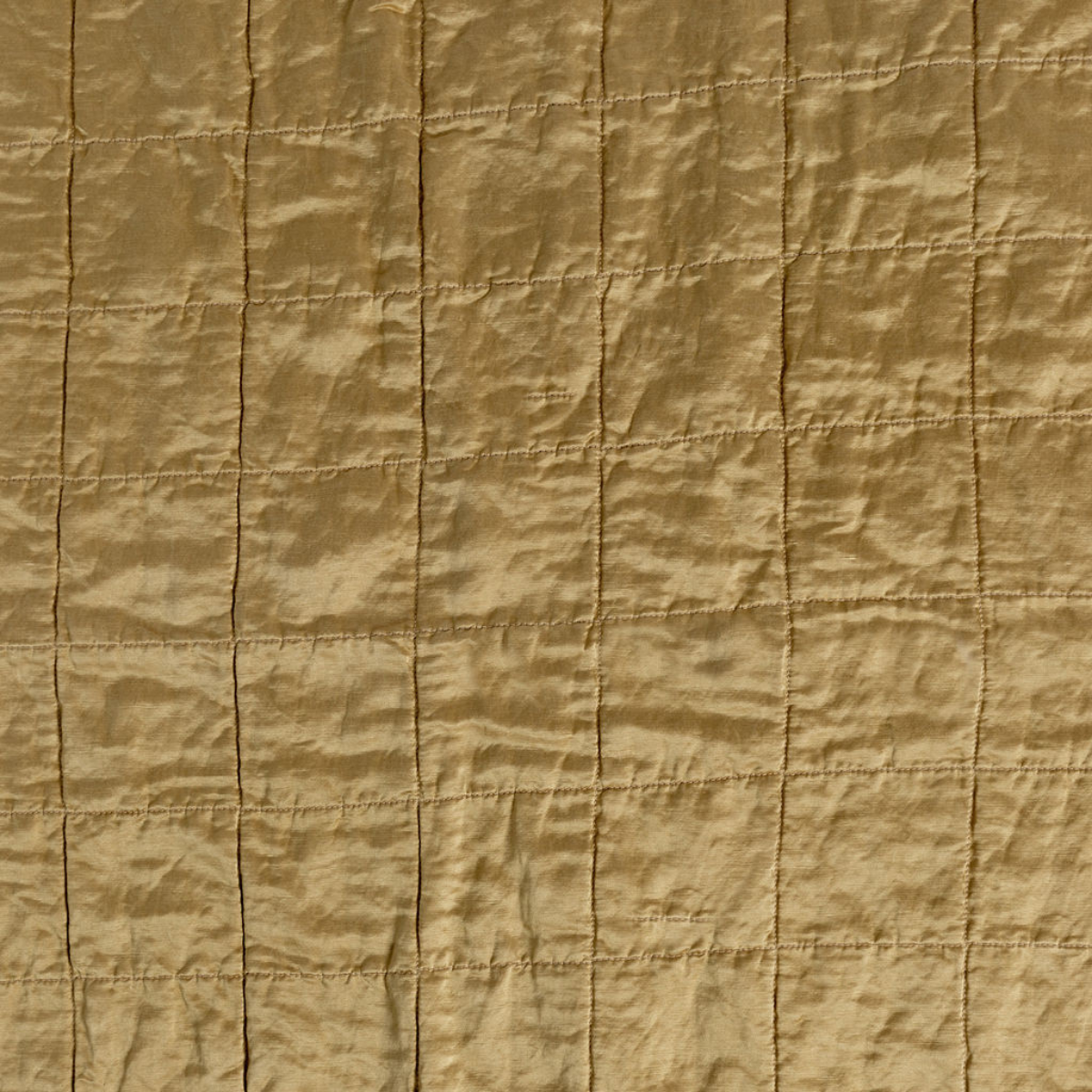 Honeycomb: a shot of square-quilted charmeuse in honeycomb, a warm golden tone.