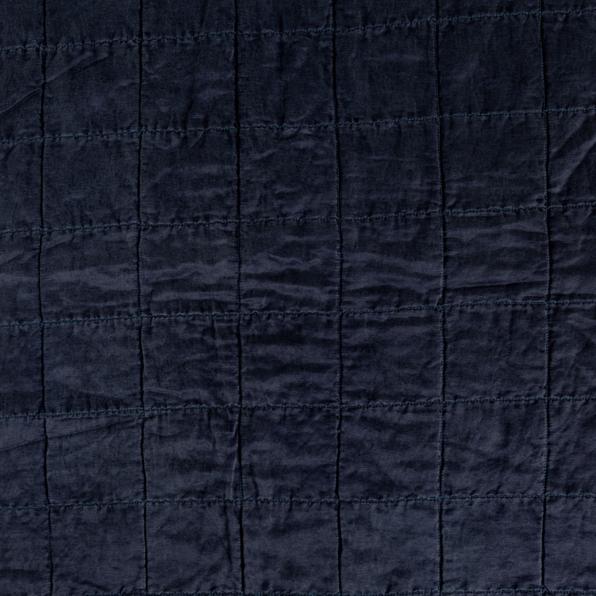 Midnight: A shot of square-quilted charmeuse in midnight, a rich indigo tone. 