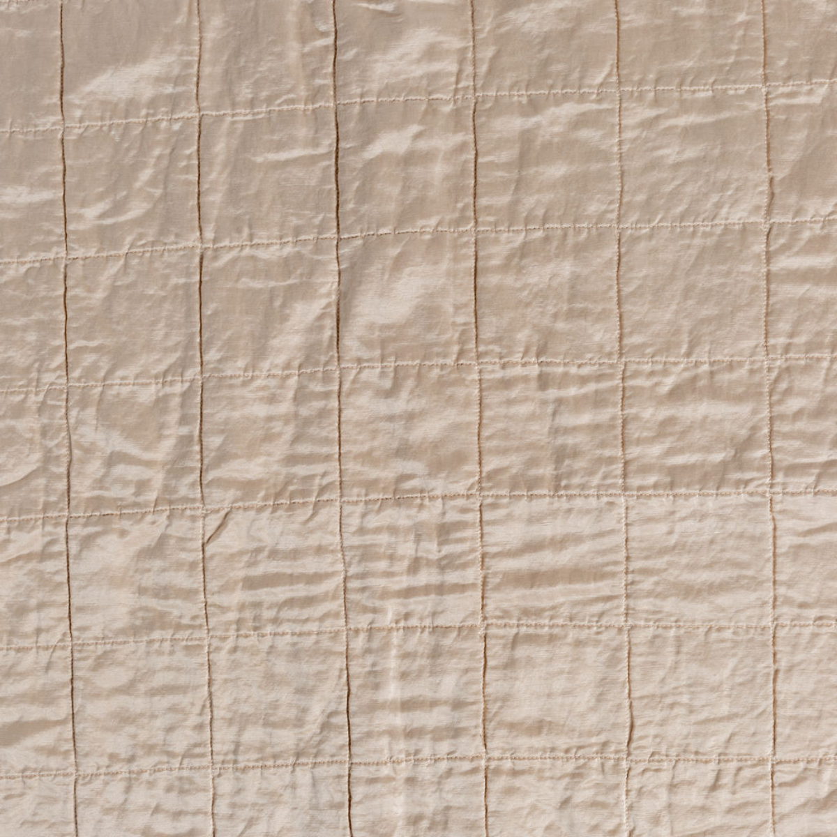 Pearl: A shot of square-quilted charmeuse in pearl, a soft rose pink tone. 