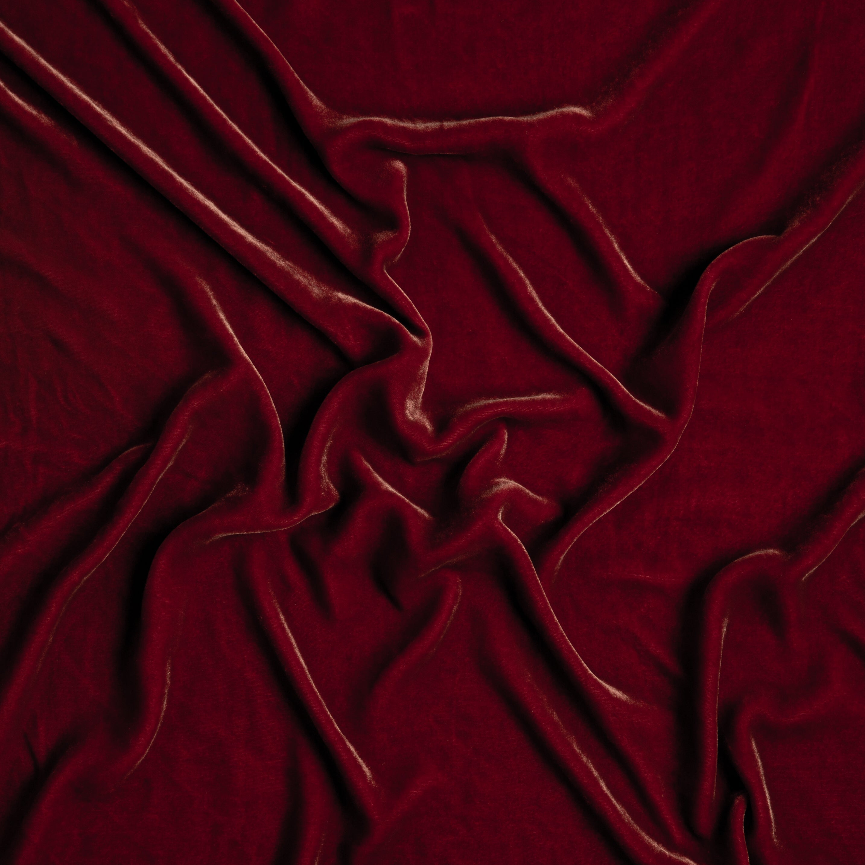 Poppy: A close up of silk velvet fabric in poppy, a warm coral pink.