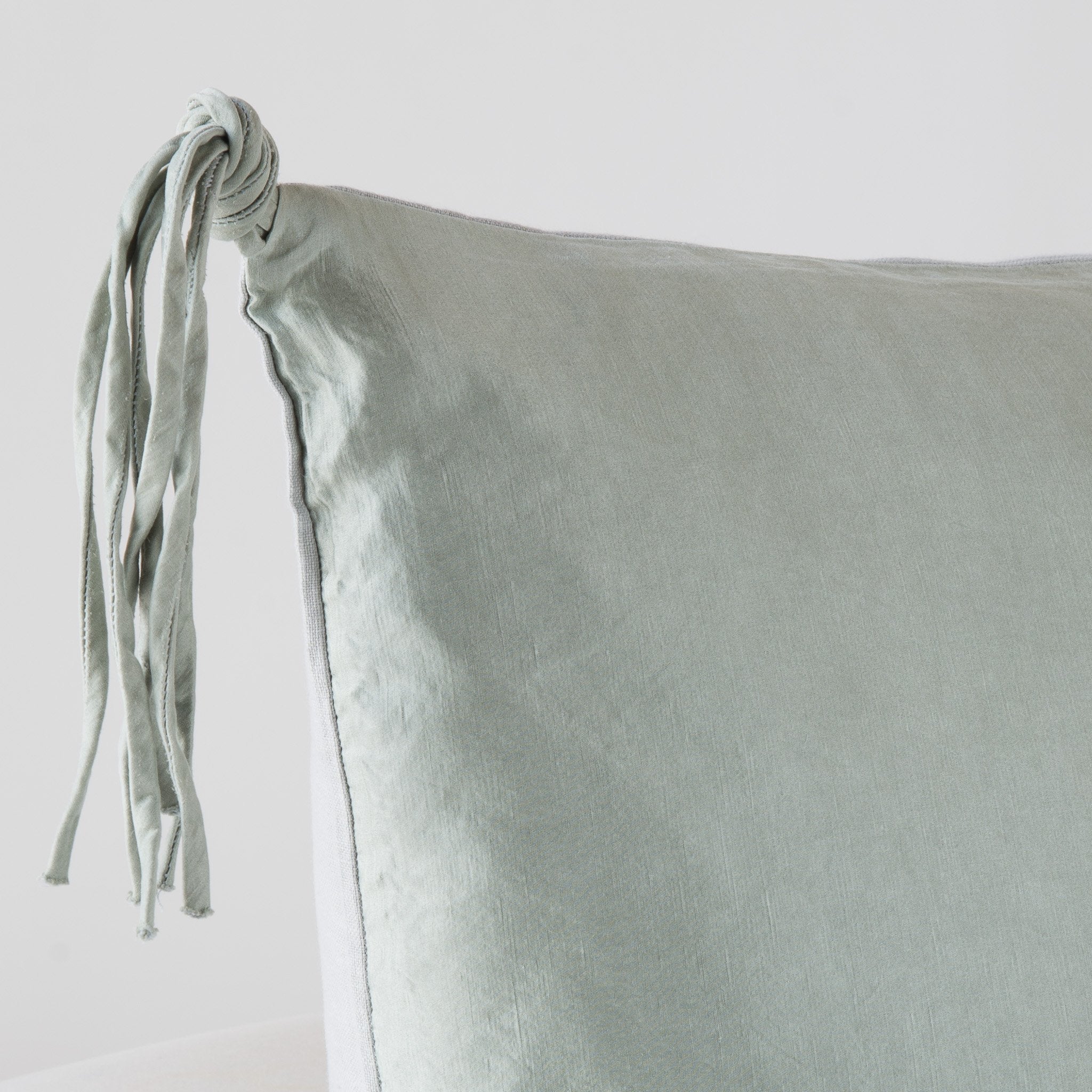Mineral: Corner detail close-up, highlighting hand-tied charmeuse tassel.