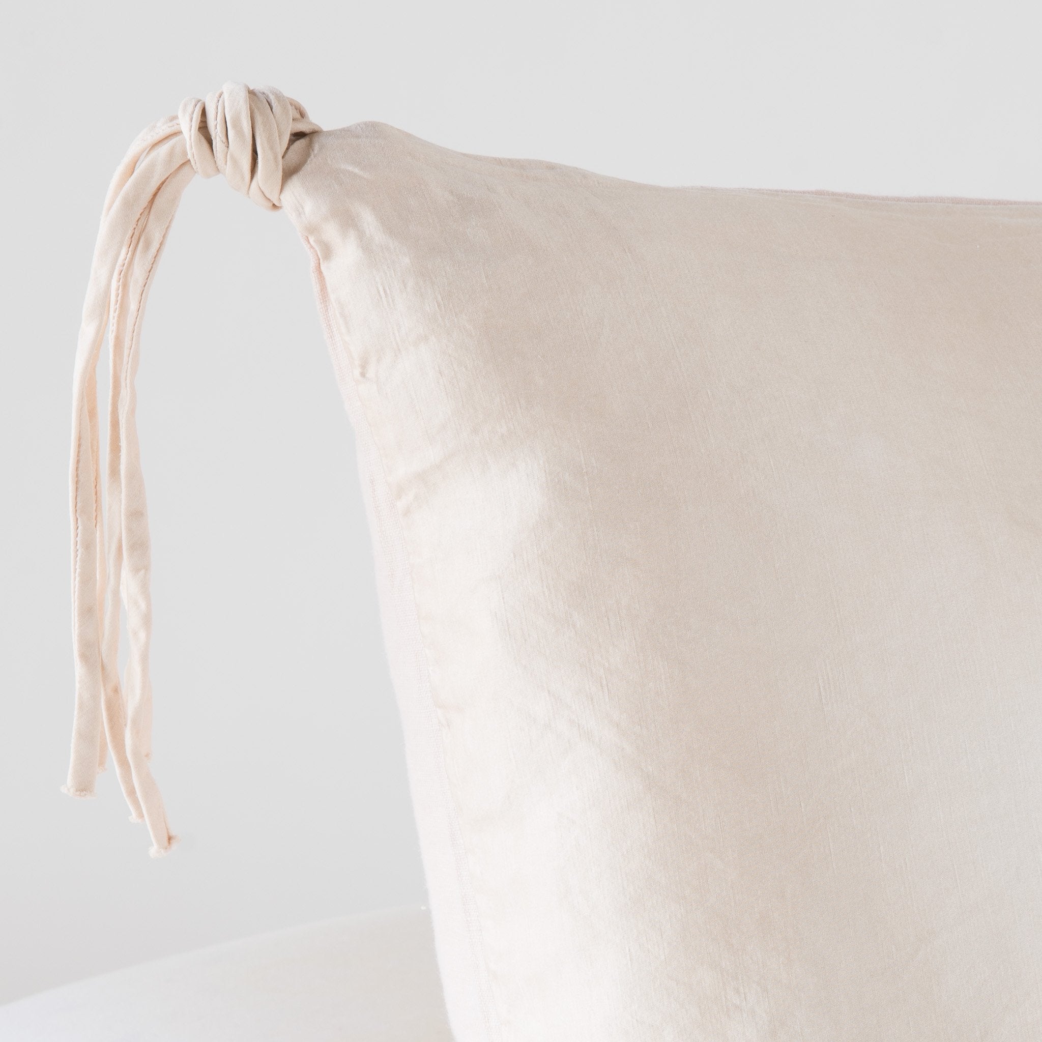 Pearl: Corner detail close-up, highlighting hand-tied charmeuse tassel.